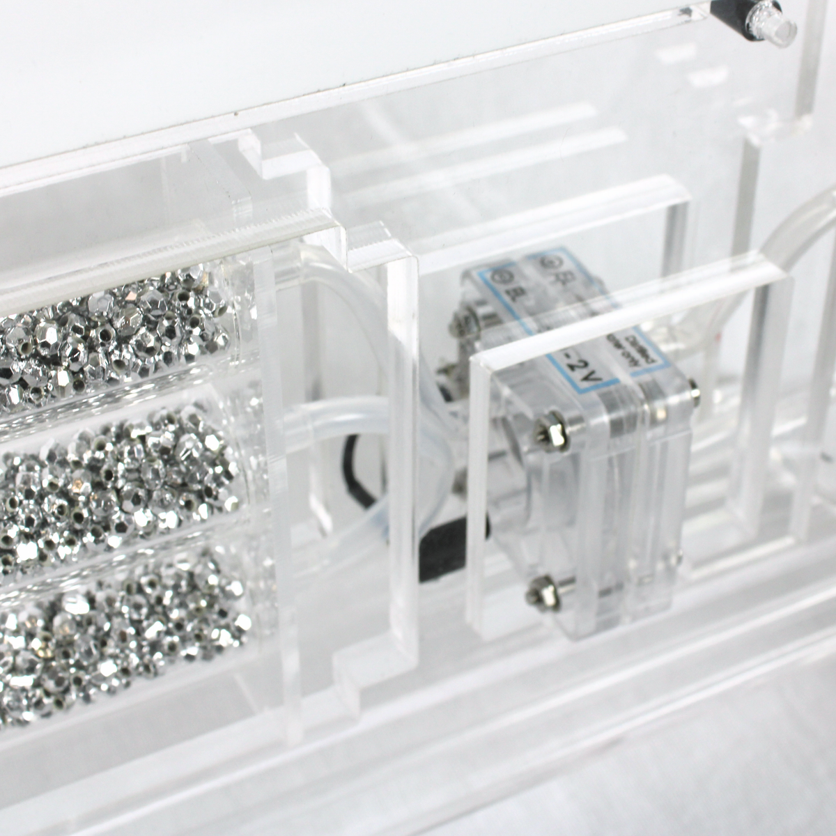 Close-up of the H-TEC D114 demo gas station showing the PEM electrolyzer mounted inside the clear acrylic housing